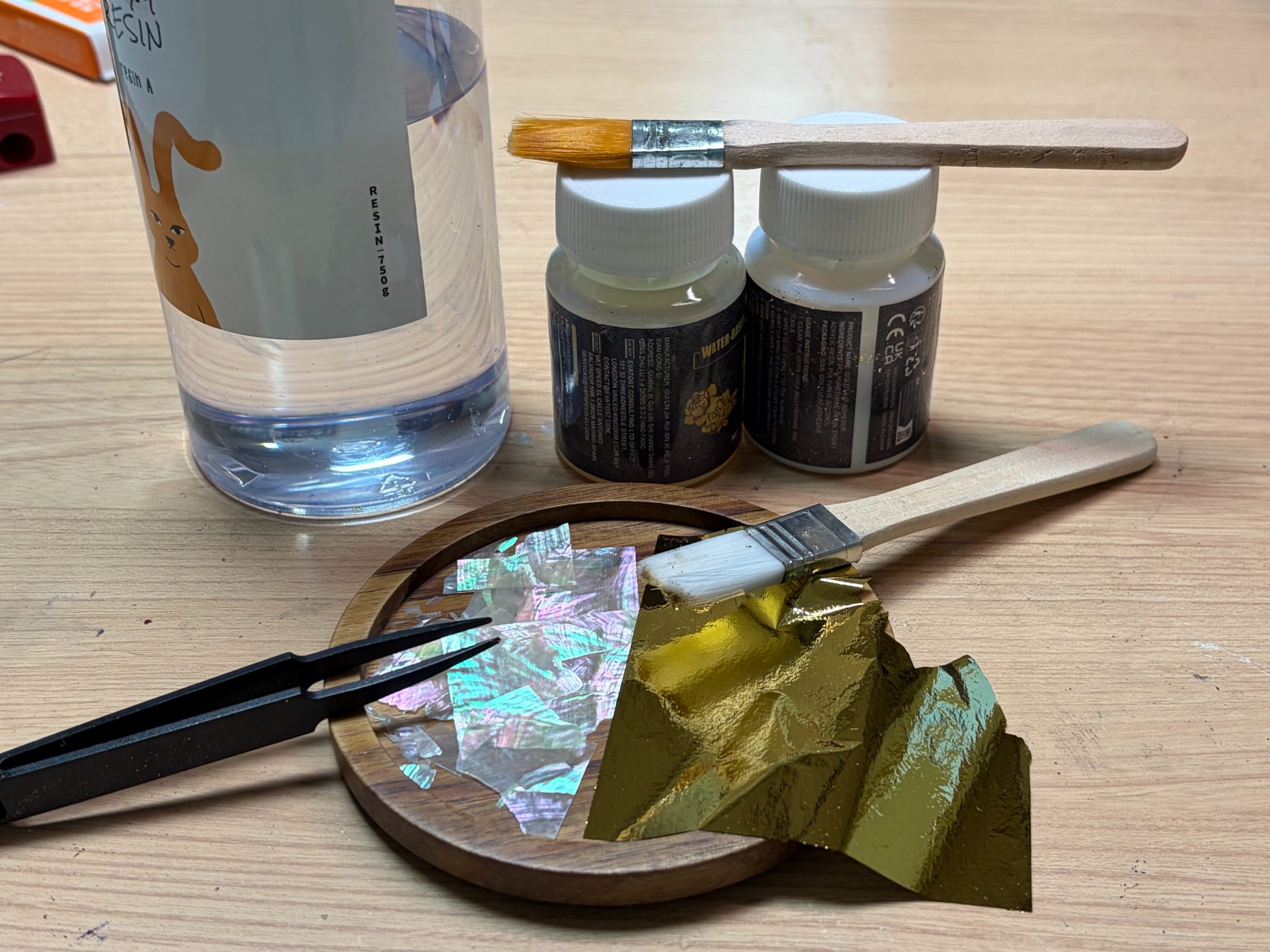 Resin, gold leaf and mother-of-pearl flakes on a coaster blank